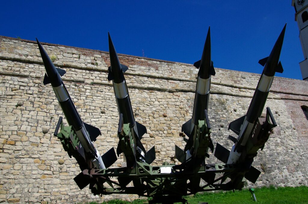 Four missiles on a launch platform with brick wall background